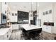Modern kitchen with white cabinets, black tile backsplash, and large island at 20428 W Elm Dr, Buckeye, AZ 85396
