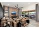 Spacious living room with exposed brick wall, large TV, and comfortable seating at 20428 W Elm Dr, Buckeye, AZ 85396