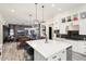 Open concept kitchen overlooking living room, featuring a large island at 20428 W Elm Dr, Buckeye, AZ 85396