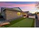 Landscaped backyard with putting green and cornhole at 20428 W Elm Dr, Buckeye, AZ 85396