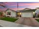 Charming house exterior with manicured lawn at sunset at 20428 W Elm Dr, Buckeye, AZ 85396