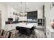 Modern kitchen with white cabinets, a large island, and black tile backsplash at 20428 W Elm Dr, Buckeye, AZ 85396