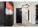 Modern entryway with black and white decor and a black door at 20428 W Elm Dr, Buckeye, AZ 85396