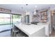 Modern kitchen features a large island, stainless steel appliances, and a brick backsplash at 7544 E Mckinley St, Scottsdale, AZ 85257