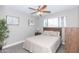 Bedroom with queen bed, ceiling fan, and wood headboard at 7544 E Mckinley St, Scottsdale, AZ 85257