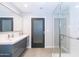 Double vanity bathroom with large mirror and shower at 7544 E Mckinley St, Scottsdale, AZ 85257