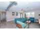 Open living area with teal sofas, wood accent tables, and an exposed duct at 7544 E Mckinley St, Scottsdale, AZ 85257