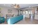 Open living room with teal sofa and modern kitchen at 7544 E Mckinley St, Scottsdale, AZ 85257