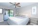 Bedroom with king bed, access to backyard, and ceiling fan at 7544 E Mckinley St, Scottsdale, AZ 85257