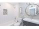Clean bathroom with white subway tiles, bathtub, and modern vanity at 7544 E Mckinley St, Scottsdale, AZ 85257