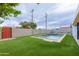 Backyard oasis with pool, artificial turf, and gate at 7544 E Mckinley St, Scottsdale, AZ 85257