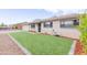 Ranch style home with artificial turf lawn at 7544 E Mckinley St, Scottsdale, AZ 85257