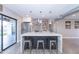 Modern kitchen island with white quartz countertops and metal stools at 7544 E Mckinley St, Scottsdale, AZ 85257