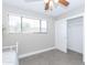Bedroom with window, ceiling fan, and sliding closet doors at 7544 E Mckinley St, Scottsdale, AZ 85257