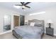 Main bedroom with plush bed, ceiling fan, and private access at 7544 E Mckinley St, Scottsdale, AZ 85257