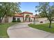 Spanish style home with a large driveway and manicured lawn at 591 E Park Ave, Gilbert, AZ 85234