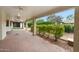Covered patio with brick flooring and lush landscaping views at 591 E Park Ave, Gilbert, AZ 85234
