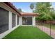 Landscaped backyard with artificial turf and gated access at 591 E Park Ave, Gilbert, AZ 85234