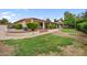 Landscaped backyard with a patio and grassy area at 591 E Park Ave, Gilbert, AZ 85234