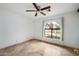 Bright bedroom featuring a ceiling fan and large window with a view at 591 E Park Ave, Gilbert, AZ 85234