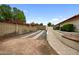 Gravel driveway with gated access and landscaping at 591 E Park Ave, Gilbert, AZ 85234