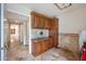 Well-appointed laundry room with wood cabinets and granite countertops at 591 E Park Ave, Gilbert, AZ 85234