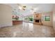 Open living room with tile floors and a fireplace at 591 E Park Ave, Gilbert, AZ 85234