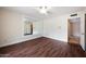 Well-lit bedroom with dark hardwood floors and a large mirror at 591 E Park Ave, Gilbert, AZ 85234