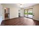 Bedroom with dark hardwood floors, private bathroom and access to backyard at 591 E Park Ave, Gilbert, AZ 85234