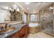 Elegant bathroom with granite countertops, soaking tub, and walk-in shower at 591 E Park Ave, Gilbert, AZ 85234