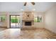 Living room with fireplace, sliding doors to patio, and tile floors at 591 E Park Ave, Gilbert, AZ 85234