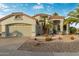 Single-story home with a two-car garage and desert landscaping at 17800 W Primrose Ln, Surprise, AZ 85374