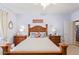 Bedroom with ornate wooden bed frame and neutral bedding at 17800 W Primrose Ln, Surprise, AZ 85374