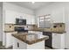 Modern kitchen featuring granite countertops and white cabinetry at 3532 W Warren Ln, Anthem, AZ 85086