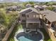 Aerial view of two-story house with a pool and backyard in a neighborhood at 3532 W Warren Ln, Anthem, AZ 85086