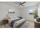 Bright bedroom with a wooden bed frame and a large window at 1455 E Tuckey Ln, Phoenix, AZ 85014