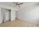 Simple bedroom with light wood floors and ceiling fan at 1455 E Tuckey Ln, Phoenix, AZ 85014