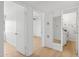 Bright hallway with light wood floors, leading to bedroom and bathroom at 1455 E Tuckey Ln, Phoenix, AZ 85014
