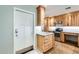 Kitchen entry with white door and light wood cabinets at 20026 N 106Th Ave, Sun City, AZ 85373