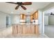 Kitchen island with light wood cabinets and granite countertop at 20026 N 106Th Ave, Sun City, AZ 85373