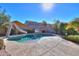 Inviting backyard oasis featuring a sparkling pool with a waterfall and slide at 36481 W Bilbao St, Maricopa, AZ 85138