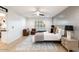 Relaxing bedroom with light wood floors and a ceiling fan at 5050 E Charter Oak Rd, Scottsdale, AZ 85254