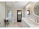 Modern bathroom with double vanity and a glass-enclosed shower at 5050 E Charter Oak Rd, Scottsdale, AZ 85254