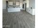 Open kitchen with white cabinets, large island, and grey wood-look tile floors at 2303 S 337Th Ave, Tonopah, AZ 85354