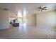 Open concept living room and kitchen with tile flooring and ceiling fan at 2303 S 337Th Ave, Tonopah, AZ 85354