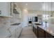 Modern kitchen with farmhouse sink, stainless steel appliances, and white cabinets at 2303 S 337Th Ave, Tonopah, AZ 85354