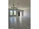 Spacious living room with tile flooring and chandelier at 2303 S 337Th Ave, Tonopah, AZ 85354