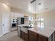 Modern kitchen with large island, white cabinets, and quartz countertops at 2303 S 337Th Ave, Tonopah, AZ 85354