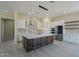 Modern kitchen with large island, stainless steel appliances, and white cabinets at 2303 S 337Th Ave, Tonopah, AZ 85354