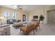 Spacious living room with tile floors, neutral walls, and modern furniture at 2303 S 337Th Ave, Tonopah, AZ 85354